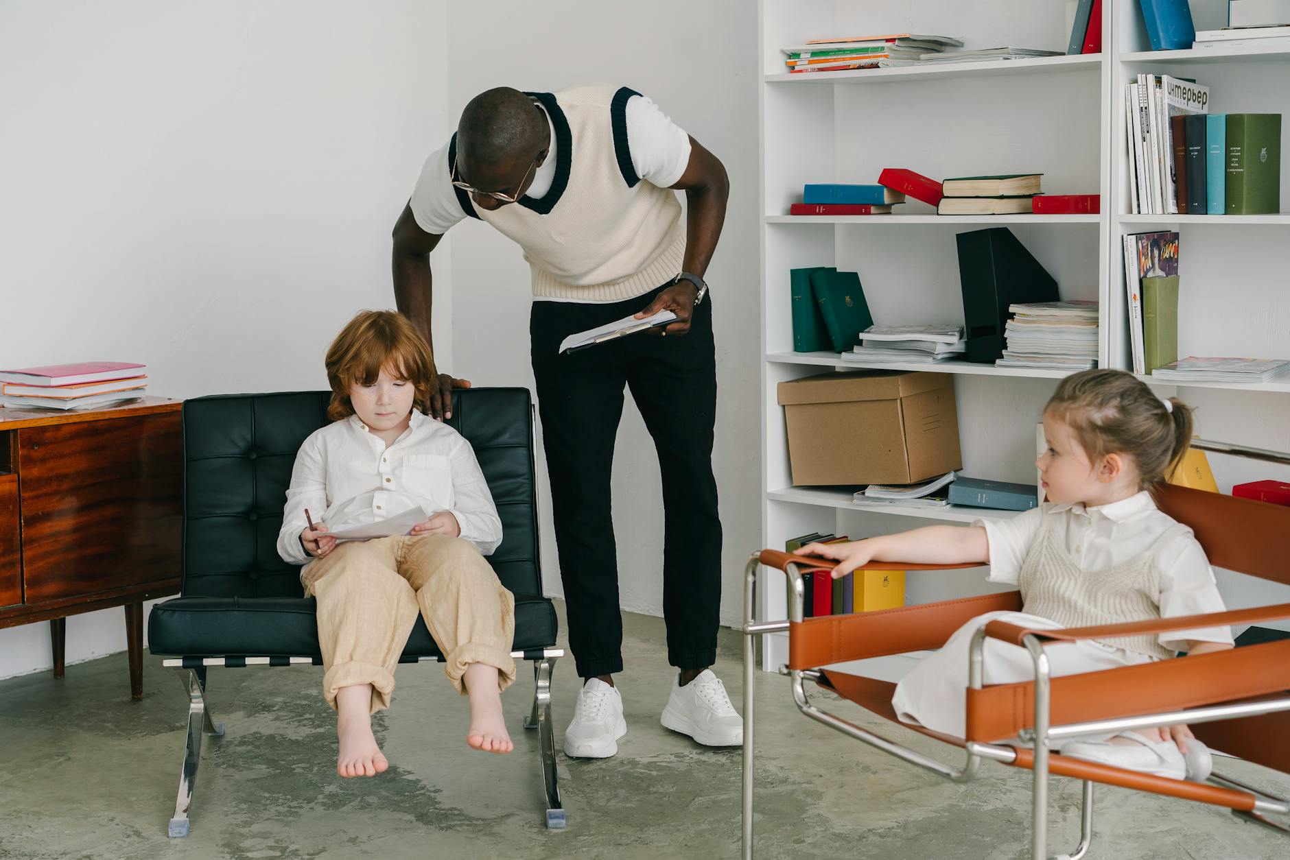 Logopeda rozmawia z dziećmi w nowoczesnym gabinecie